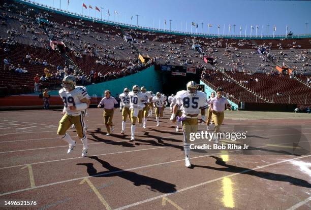 University of Washington Head Coach Don James leads his team onto field before game between University of Southern California and University of...