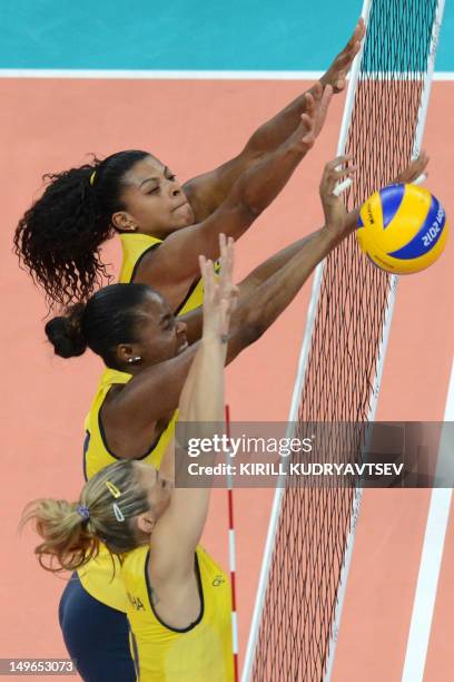 Brazil's Paula Pequeno , Fabiana Claudino and Thaisa Menezes attempt to block during the Women's preliminary pool B volleyball match between Brazil...