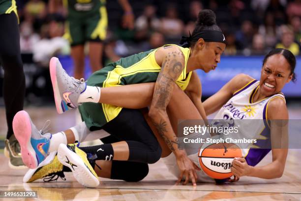 Yvonne Turner of the Seattle Storm and Azura Stevens of the Los Angeles Sparks dive for the ball during the second quarter at Climate Pledge Arena on...