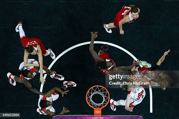 Lindsay Whalen of United States and Bahar Caglar of Turkey compete for a rebound in the Women's Basketball Preliminary Round match between the United...