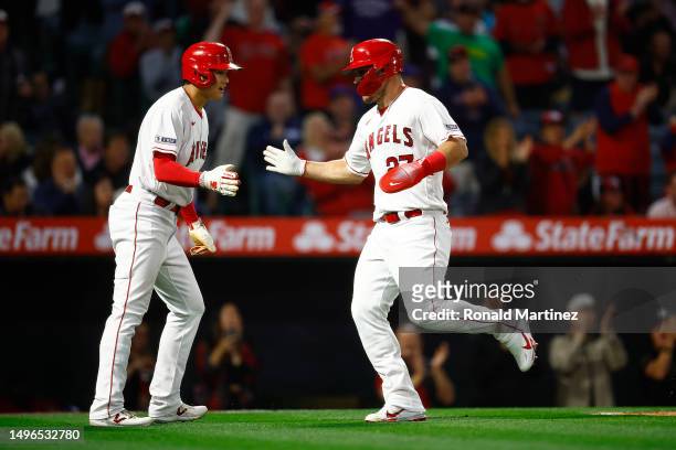 Shohei Ohtani and Mike Trout of the Los Angeles Angels celebrate after scoring against the Chicago Cubs in the fifth inning at Angel Stadium of...