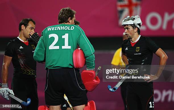 Tobias Hauke talks with goalkeeper Max Winhold of Germany priorto a South Korea penalty during the Men's preliminary Hockey match between South Korea...