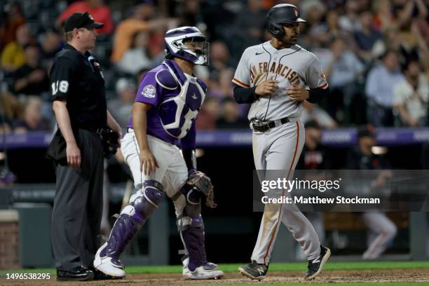 LaMonte Wade Jr. #31 of the San Francisco Giants scores on a J.D. Davis double against the Colorado Rockies in the fifth inning at Coors Field on...