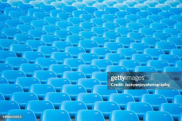 empty blue arena seats with numbers in stadium - tribüne stock-fotos und bilder