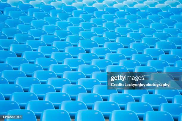 empty blue arena seats with numbers in stadium - bleachers stock pictures, royalty-free photos & images