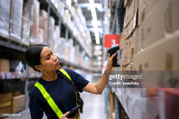 employee check merchandise at warehouse. - warehouse worker stock pictures, royalty-free photos & images