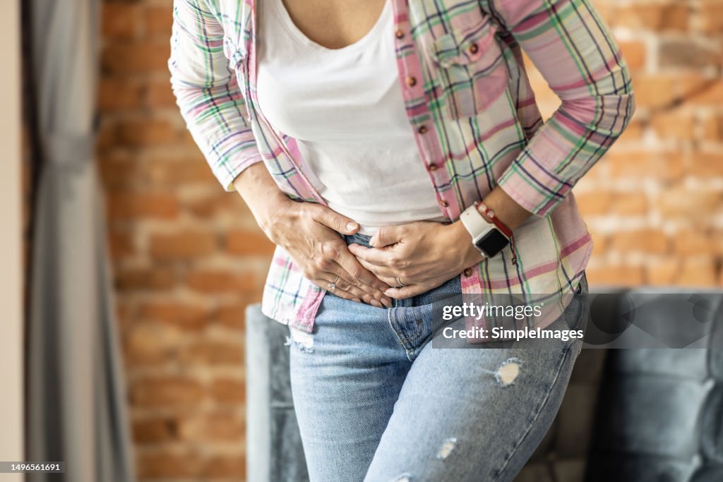 A woman is in pain due to a gallbladder attack or gallstones