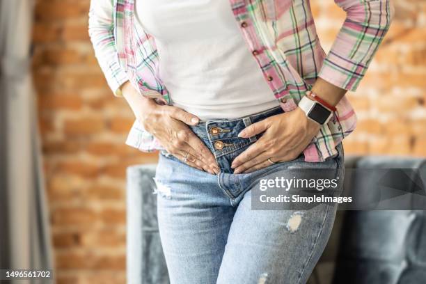 a woman suffering from menstrual pain. she suffers from pain due to ovarian ovulation. - endometriosis stock-fotos und bilder