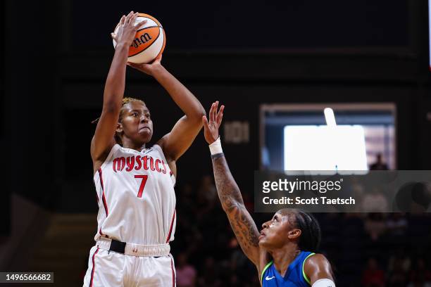 Ariel Atkins of the Washington Mystics shoots the ball against Tiffany Mitchell of the Minnesota Lynx during the first half of the game at...