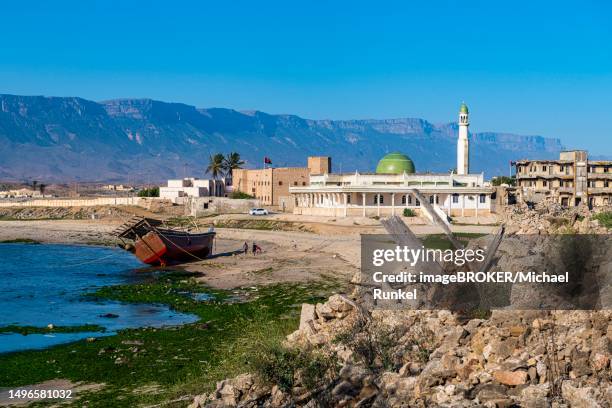 old dhow on the beach of mirbat, salalah, oman - dhofar stock pictures, royalty-free photos & images