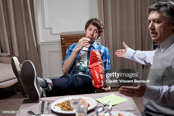 father and son at the dinner table - rudeness stock pictures, royalty-free photos & images