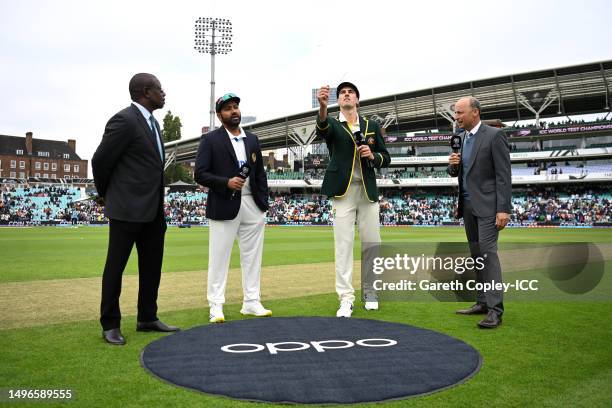 Pat Cummins of Australia tosses the coin alongside Rohit Sharma of India, Match referee Richie Richardson and TV commentator Nasser Hussain during...