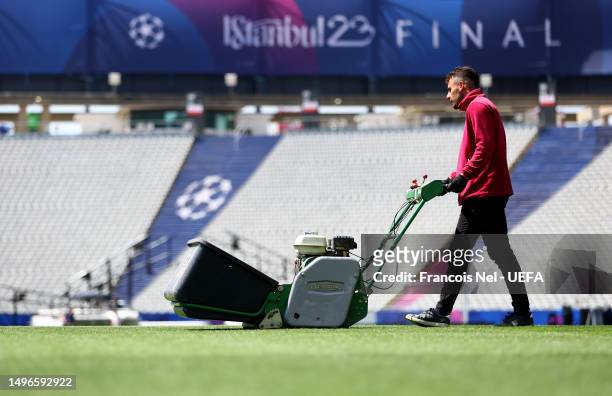 Ground staff mow the pitch at the Ataturk Olympic Stadium mows the grass ahead of the UEFA Champions League 2022/23 final on June 07, 2023 in...