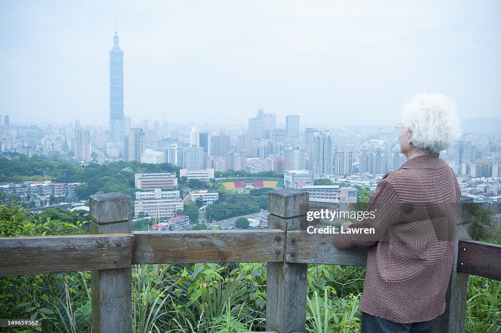 Senior woman looking at Taipei 101