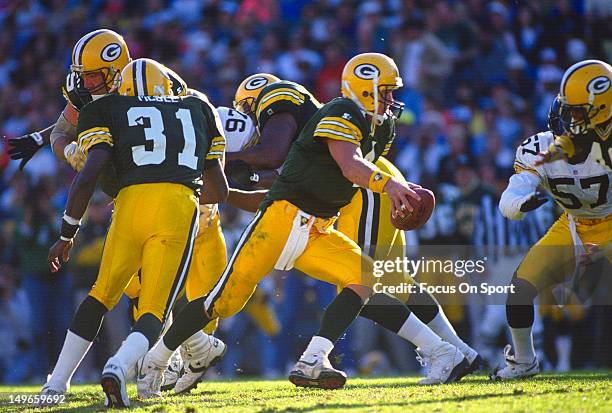 Brett Favre of the Green Bay Packers turns to hand the ball off against the Pittsburgh Steelers during an NFL football game at Lambeau Field...