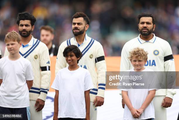 Ravindra Jadeja, Virat Kohli and Rohit Sharma of India stand during the national anthem during day one of the ICC World Test Championship Final...