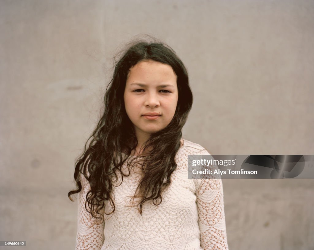 Girl Standing in Front of a Wall