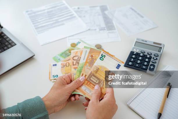 close up of woman's hands counting euro banknotes planning home budget - saving up for a rainy day stock pictures, royalty-free photos & images