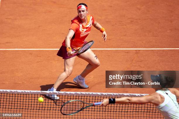 Ons Jabeur of Tunisia plays a passing shot at the net against Beatriz Haddad Maia of Brazil in the quarter-final round of the singles competition on...