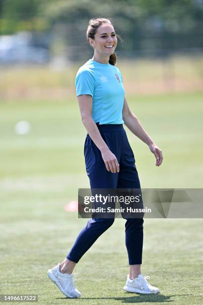 Catherine, Princess of Wales takes part in rugby drills on the pitch with a number of local and professional players during her visit to Maidenhead...