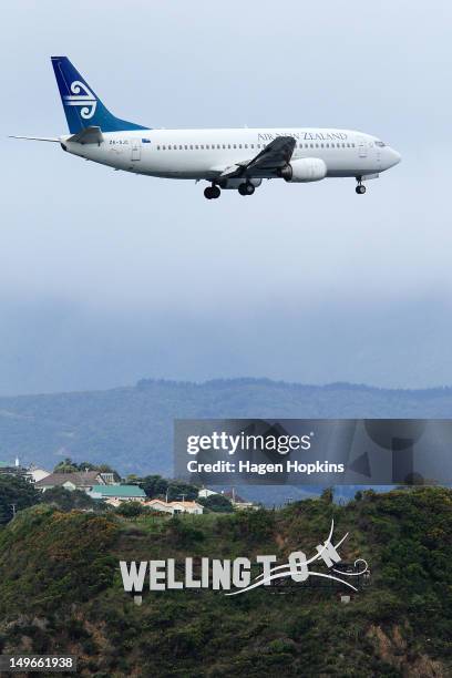 An Air New Zealand plane flies over Wellington Airport's "Wellington Blown Away" sign on August 2, 2012 in Wellington, New Zealand. The city was...