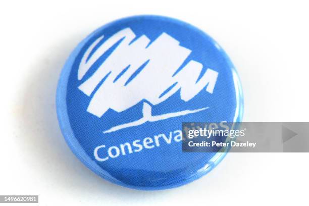 Photo illustration of a Conservative Party campaign badge photographed June 2023.