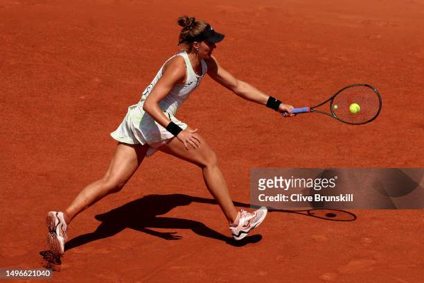 Beatriz Haddad Maia of Brazil plays a forehand against Ons Jabeur of Tunisia during the Women's Singles Quarter Final match on Day Eleven of the 2023...
