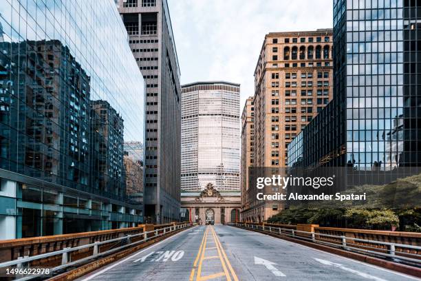 grand central station surrounded by tall skyscrapers in midtown manhattan, new york city, usa - grand central station manhattan stockfoto's en -beelden