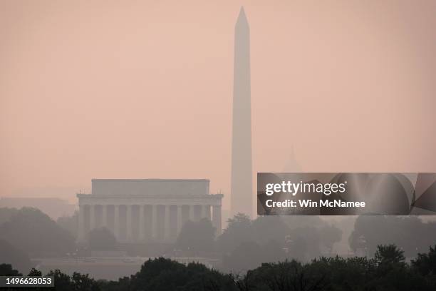 Hazy skies caused by Canadian wildfires blanket the monuments and skyline of Washington, DC on June 7, 2023 as seen from Arlington, Virginia. The...