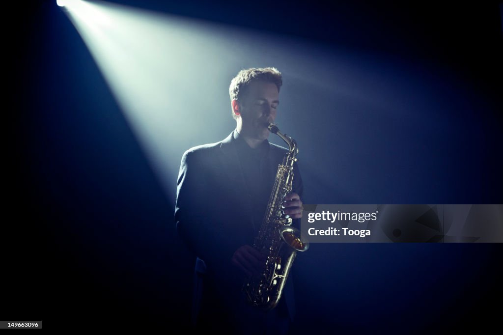 Musician playing saxophone on stage