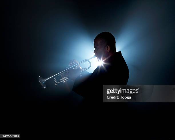 trumpeter playing horn on stage - musician studio stock pictures, royalty-free photos & images