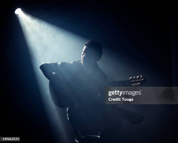 man sitting and playing acoustic guitar - musician studio stock pictures, royalty-free photos & images