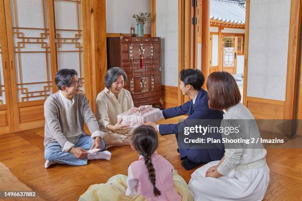 holidays, hanok, family, smile, handing over - chuseok stock pictures, royalty-free photos & images