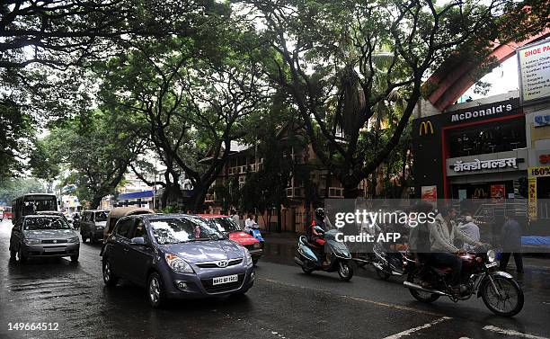 Traffic moves outside the MacDonald outlet, one of the blast site in Pune on August 2, 2012. Four low-intensity blasts hit the western Indian city of...