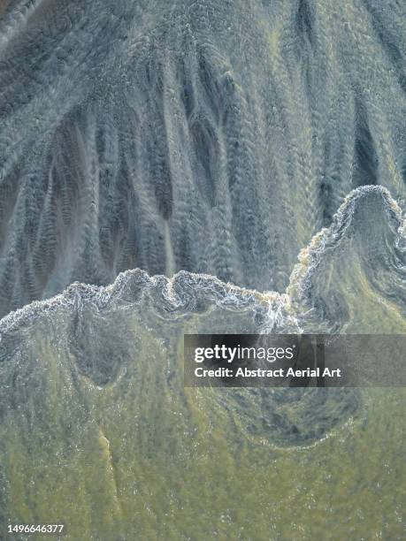 gentle ocean wave and pasut beach textures shot from a drone point of view, canggu, bali, indonesia - sediment stock-fotos und bilder