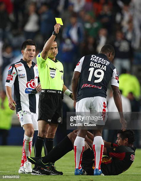 Referee Miguel Angel Flores shows a yellow card during a match between Pachuca and Leones Negros as part of the Cup MX 2012 at Hidalgo Stadium on...