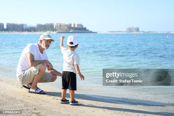Baby Throwing Rocks 3 Generations Throwing Rocks Photos and Premium High Res Pictures ...