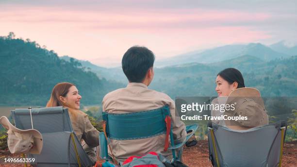 group of friends asian camp forest adventuretogether in summer at nature. asian camping in their tent on the sunny day. three young asian enjoy camping with morning coffee. travel in summer holiday concept - coffee break party photos et images de collection