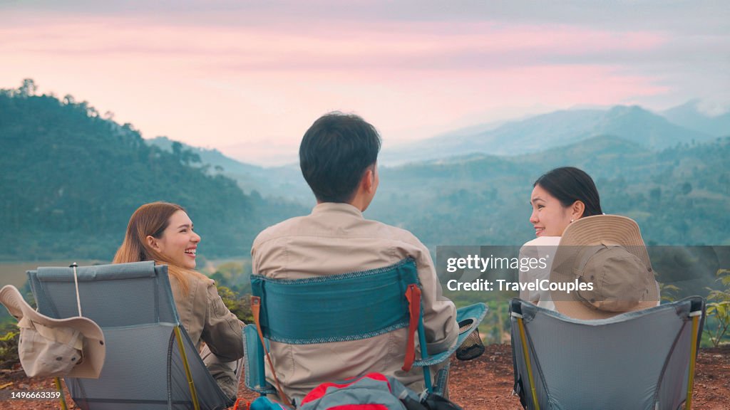 Group of friends asian camp forest adventuretogether in summer at nature. Asian camping in their tent on the sunny day. Three young asian enjoy camping with morning coffee. Travel in summer holiday concept