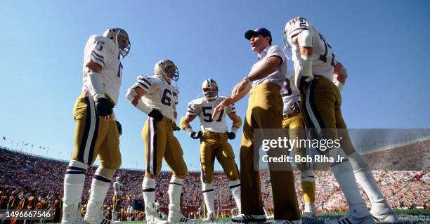 University of Washington football Coach works with players before game action between University of Southern California and University of Washington...