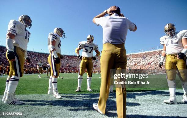 University of Washington football Coach works with players before game action between University of Southern California and University of Washington...