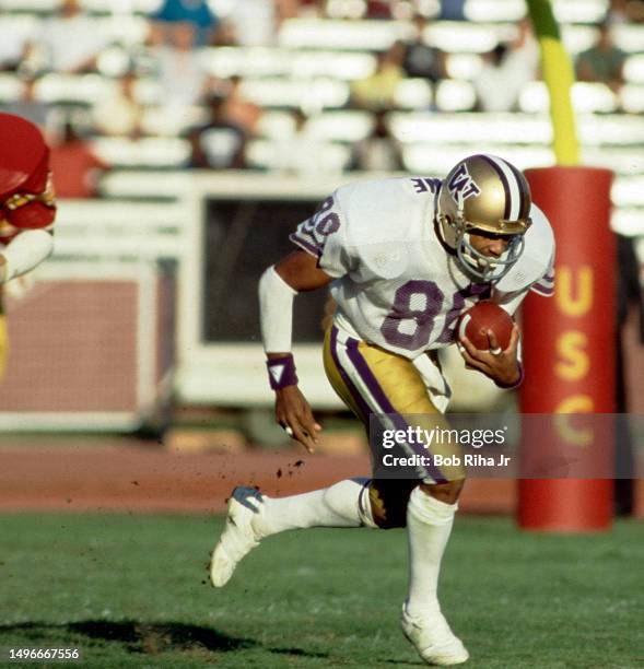 University of Washington Receiver Danny Greene heads up-field after catch during game against University of Southern California at Los Angeles...