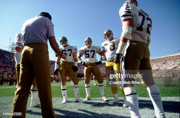 University of Washington football Coach works with players before game action between University of Southern California and University of Washington...