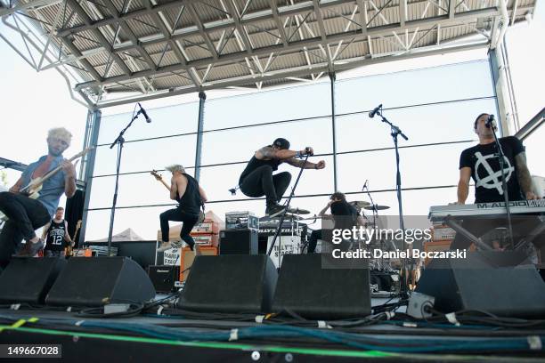 Lee Gaze, Stuart Richardson, Ian Watkins, Mike Lewis and Jamie Oliver of Lostprophets perform on stage during Warped Tour at Marcus Amphitheatre on...