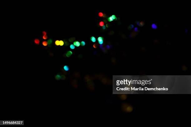 multicolored blurred bokeh lights on black background. glitter sparkle confetti - rainbow confetti stock pictures, royalty-free photos & images