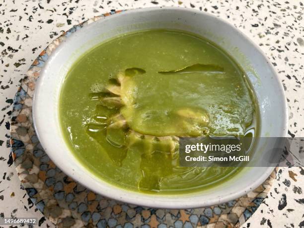 bowl of crema de sopa de verde de arveja, brócoli, puerra y habas con salchicha de ternera (cream of green peas, broccoli, leek, and broad bean soup with veal sausage) - pureed 個照片及圖片檔