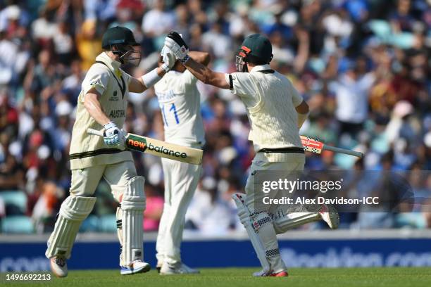 Travis Head of Australia celebrates with teammate Steven Smith after scoring a century during day one of the ICC World Test Championship Final...