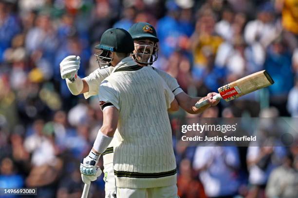 Travis Head of Australia celebrates with teammate Steven Smith after scoring a century during day one of the ICC World Test Championship Final...