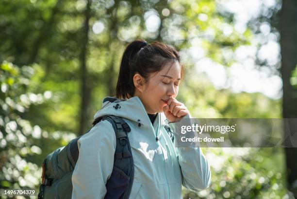 coughing female in forest - spring allergies stock pictures, royalty-free photos & images