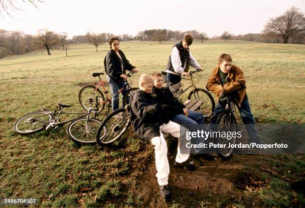 School children congregate with their bicycles on and around a bench on Hampstead Heath in north London in 1996.